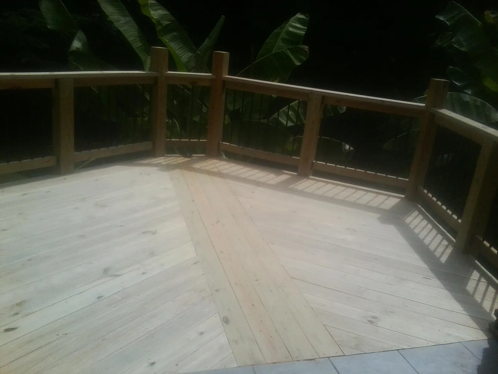 New wood deck and railing built off the back of a home in Clairfield